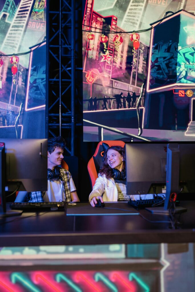 Two gamers immersed in a video game competition in a high-tech setup.